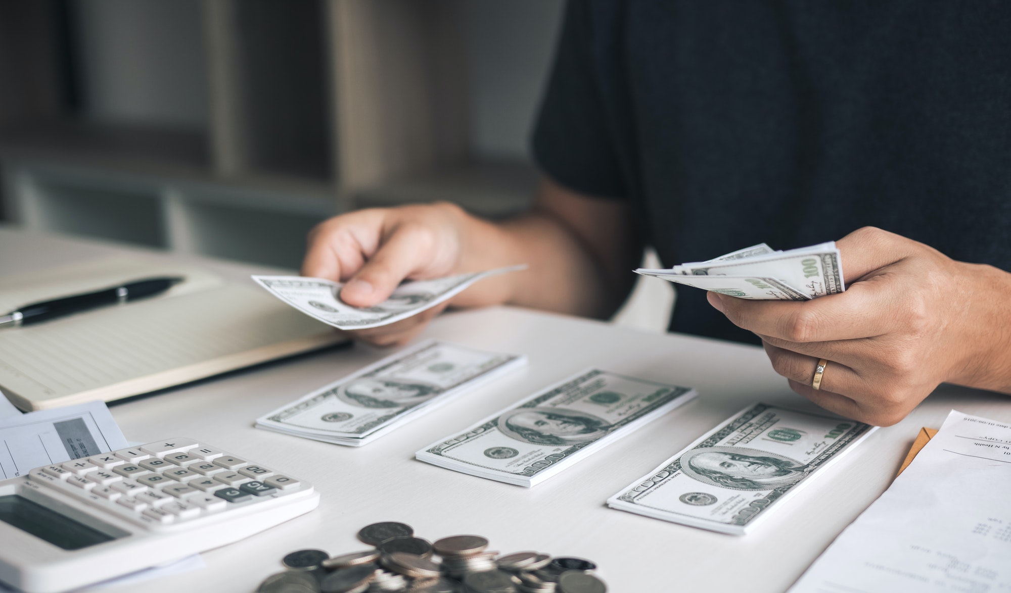 asian-men-are-holding-banknotes-in-cash-and-placed-on-the-table-with-the-idea-of-saving-money-.jpg